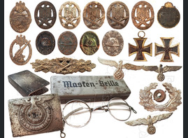Badges found at the site where after the surrender there was a camp for German prisoners of war